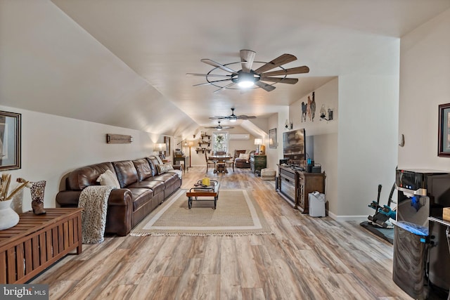 living room with ceiling fan, lofted ceiling, and light wood-type flooring