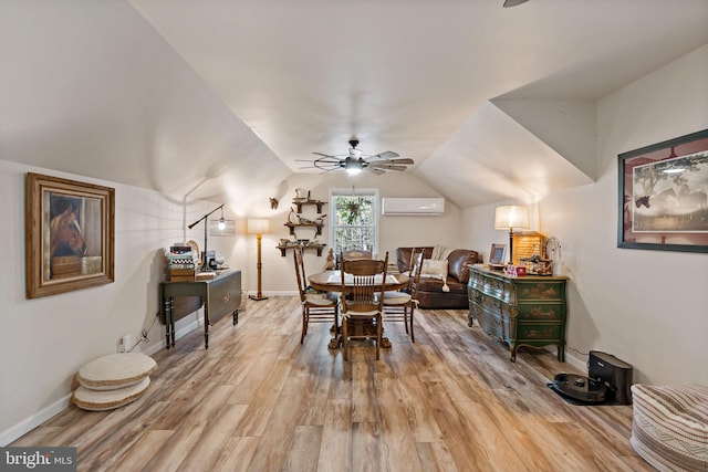 dining area featuring hardwood / wood-style floors, vaulted ceiling, an AC wall unit, and ceiling fan