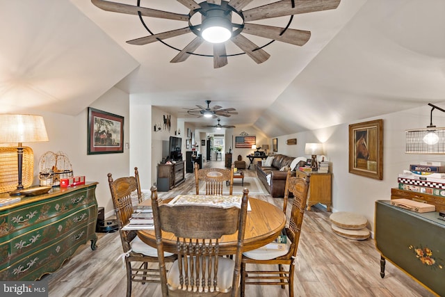 dining space with lofted ceiling, ceiling fan, and light wood-type flooring