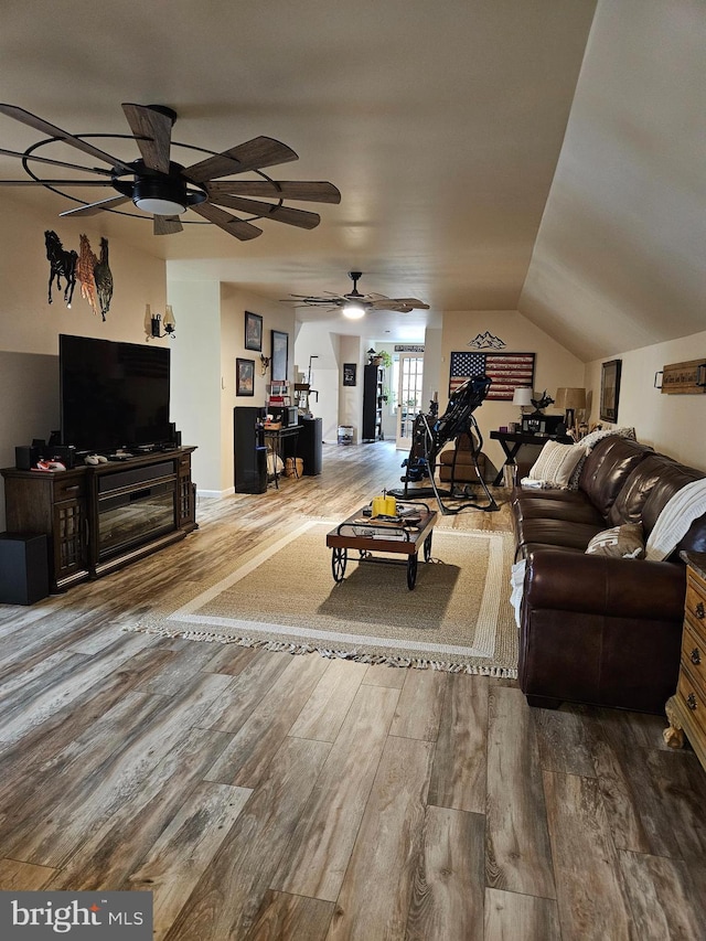 living room with hardwood / wood-style flooring and vaulted ceiling