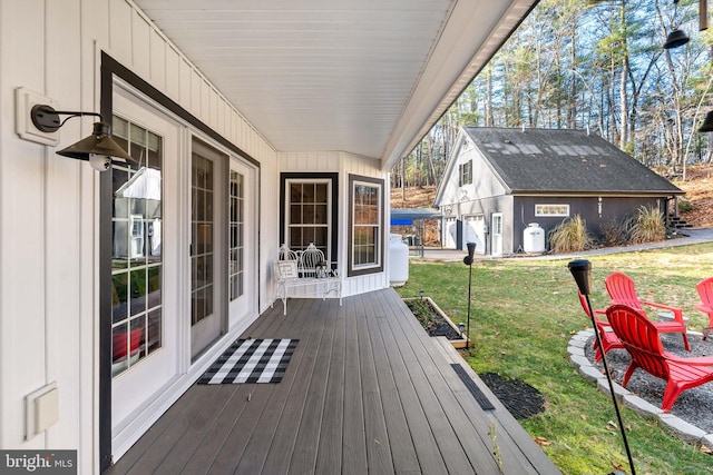 deck featuring an outbuilding and a lawn