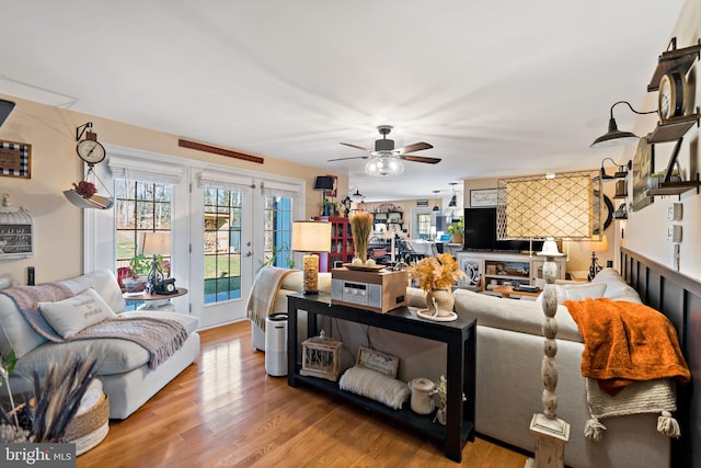 living room with ceiling fan and wood-type flooring