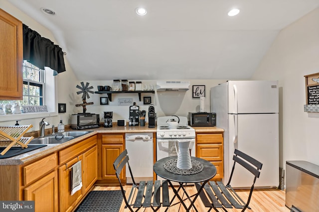 kitchen featuring white appliances, extractor fan, sink, light hardwood / wood-style floors, and lofted ceiling