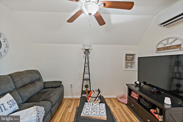 living room featuring lofted ceiling, ceiling fan, wood-type flooring, and a wall unit AC