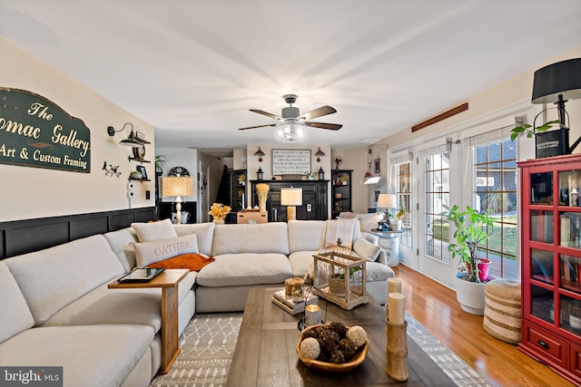 living room with light hardwood / wood-style floors and ceiling fan