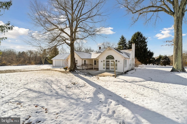 ranch-style house featuring an outbuilding and a garage