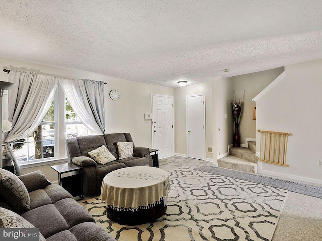 living room with a textured ceiling and light carpet