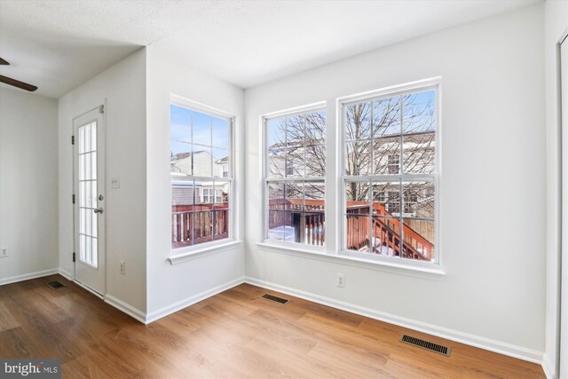 interior space with ceiling fan and wood-type flooring