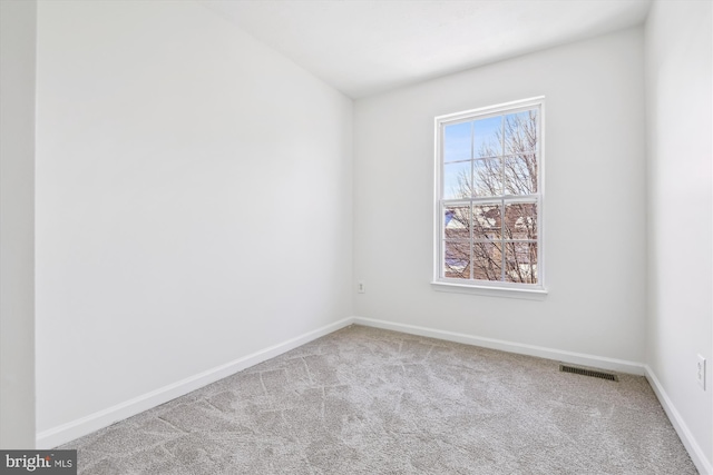 unfurnished room with light carpet