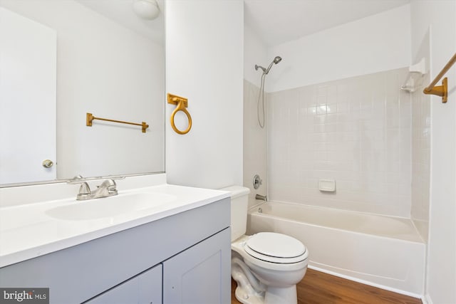 full bathroom with toilet, shower / bathtub combination, wood-type flooring, and vanity