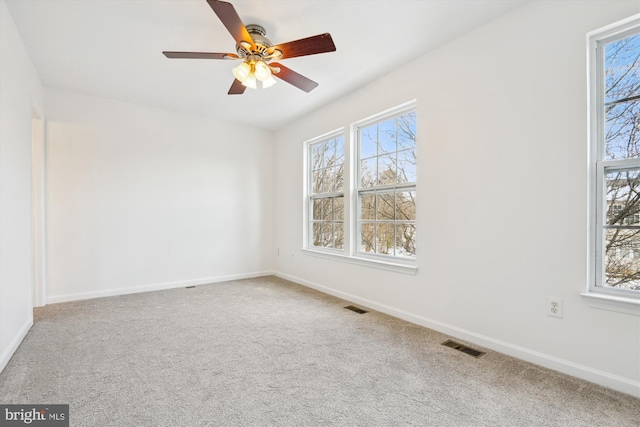 spare room featuring carpet flooring and ceiling fan