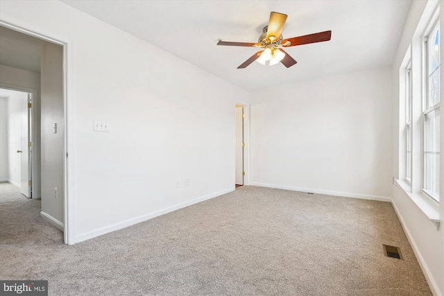 carpeted empty room with ceiling fan