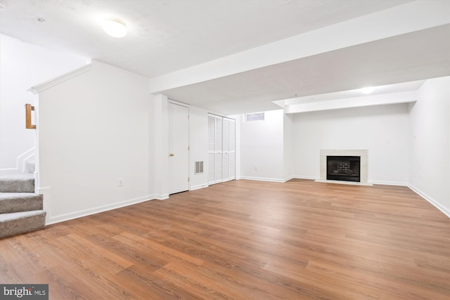 basement with hardwood / wood-style floors