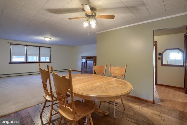 dining room featuring hardwood / wood-style flooring, a wealth of natural light, ornamental molding, and ceiling fan