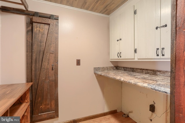 laundry room featuring crown molding, light hardwood / wood-style flooring, and wood ceiling