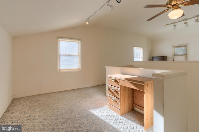 unfurnished office featuring light carpet, track lighting, lofted ceiling, and ceiling fan