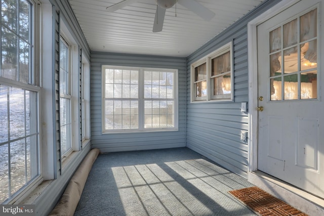 unfurnished sunroom with ceiling fan and a healthy amount of sunlight