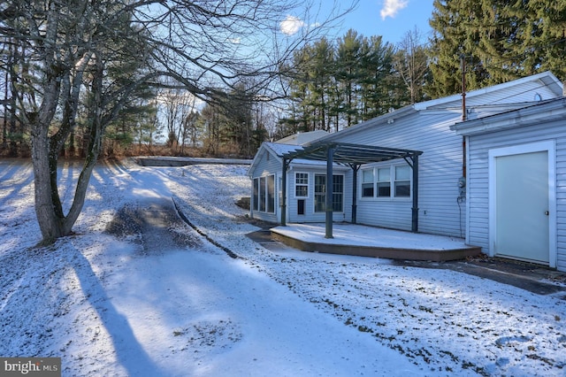 yard covered in snow featuring a wooden deck