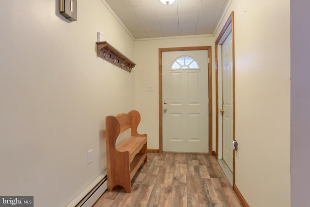 entryway with light hardwood / wood-style floors, a baseboard radiator, and ornamental molding