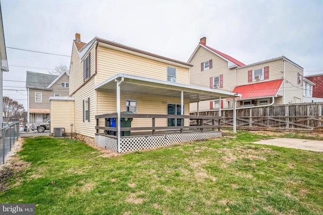 back of house with covered porch and a yard