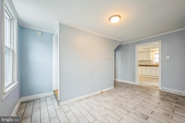 spare room with light hardwood / wood-style floors and ornamental molding