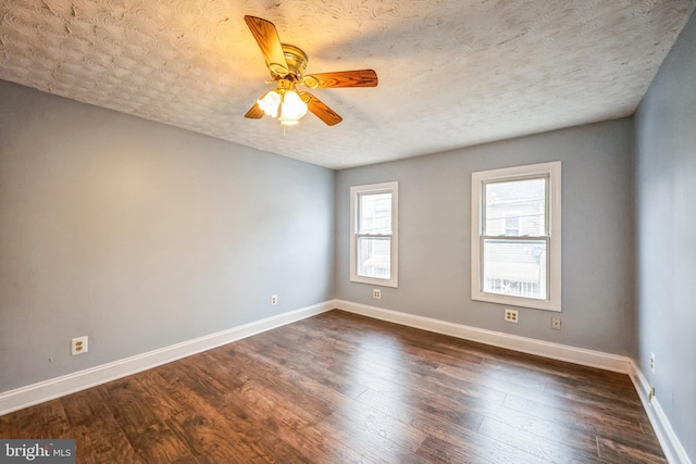 unfurnished room featuring dark hardwood / wood-style flooring, a textured ceiling, and ceiling fan