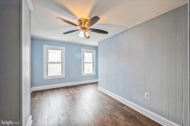 empty room featuring crown molding, dark hardwood / wood-style flooring, and ceiling fan