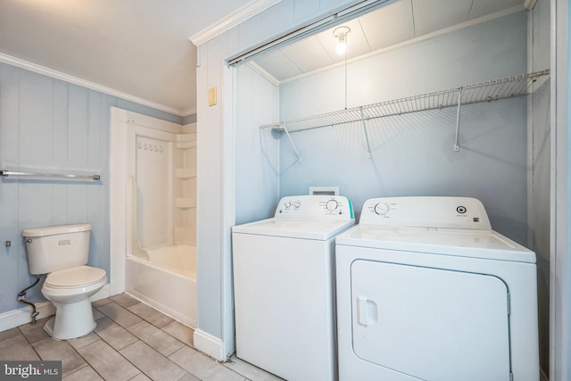 clothes washing area featuring separate washer and dryer and crown molding