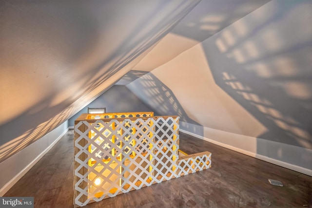 bonus room featuring dark hardwood / wood-style flooring and vaulted ceiling