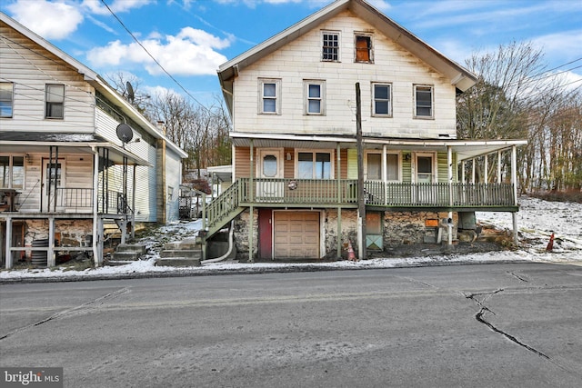 view of front of house featuring a porch and a garage