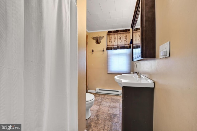 bathroom featuring vanity, toilet, ornamental molding, and a baseboard heating unit