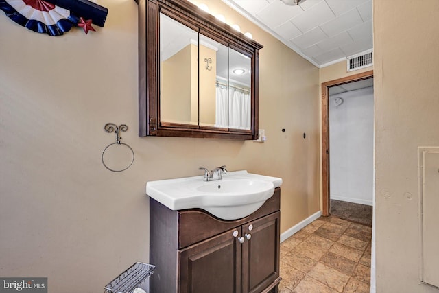 bathroom with vanity and crown molding