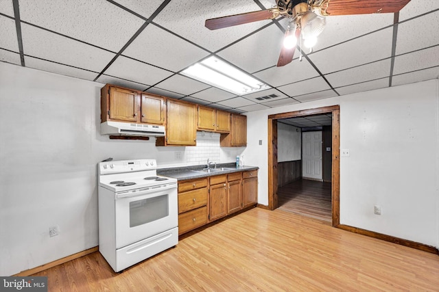 kitchen featuring a paneled ceiling, light hardwood / wood-style floors, sink, and white electric stove