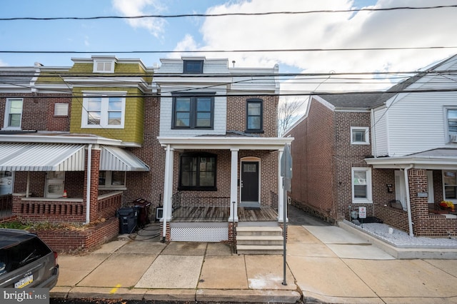 townhome / multi-family property with a porch