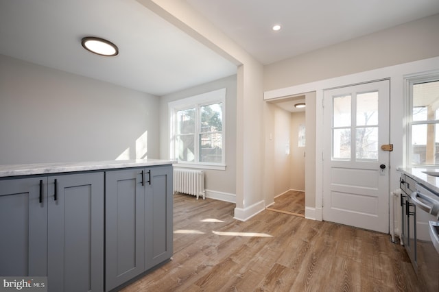 foyer featuring light wood-type flooring and radiator