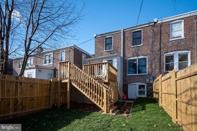 rear view of property with a yard