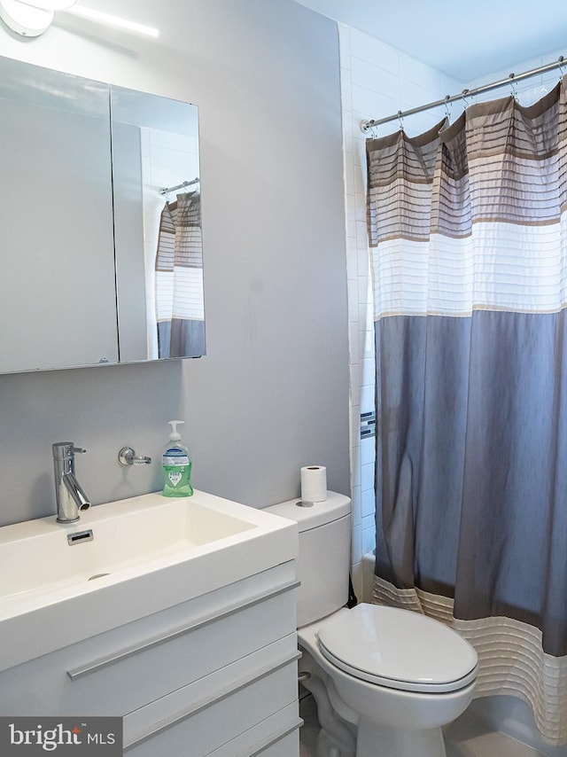 full bathroom featuring vanity, shower / bath combination with curtain, and toilet