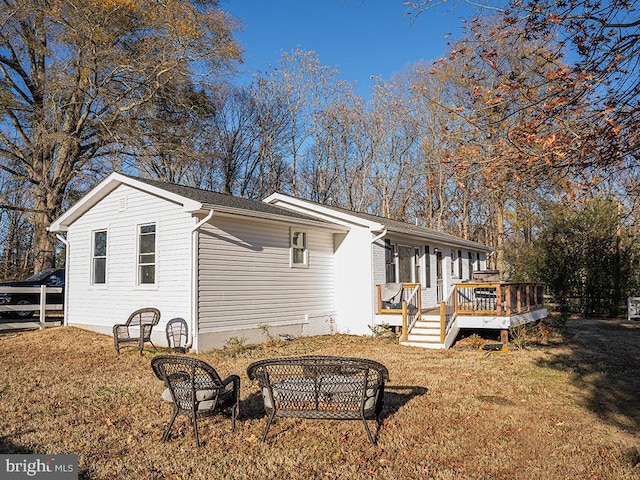 view of side of property with a deck and a yard