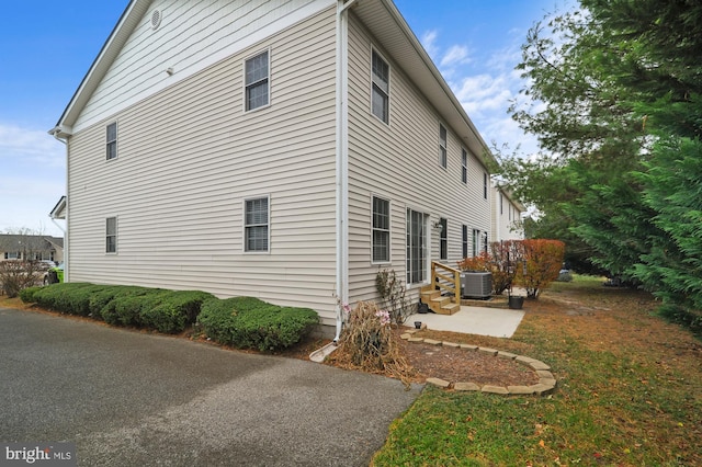 view of home's exterior with central AC and a patio area