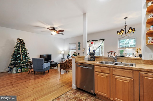 kitchen featuring sink, hanging light fixtures, stainless steel dishwasher, hardwood / wood-style floors, and ceiling fan with notable chandelier