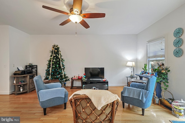 living room with ceiling fan and light wood-type flooring