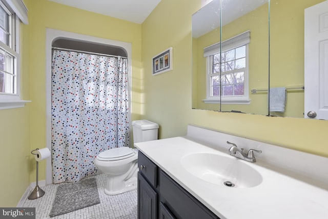 bathroom with tile patterned floors, a shower with curtain, vanity, and toilet