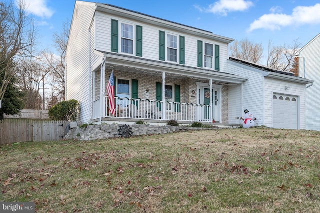 view of front property featuring a garage and a front lawn