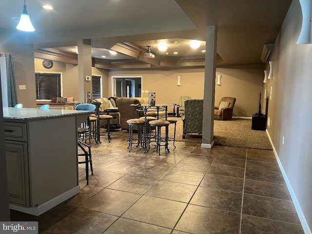 dining space featuring dark tile patterned floors and baseboards