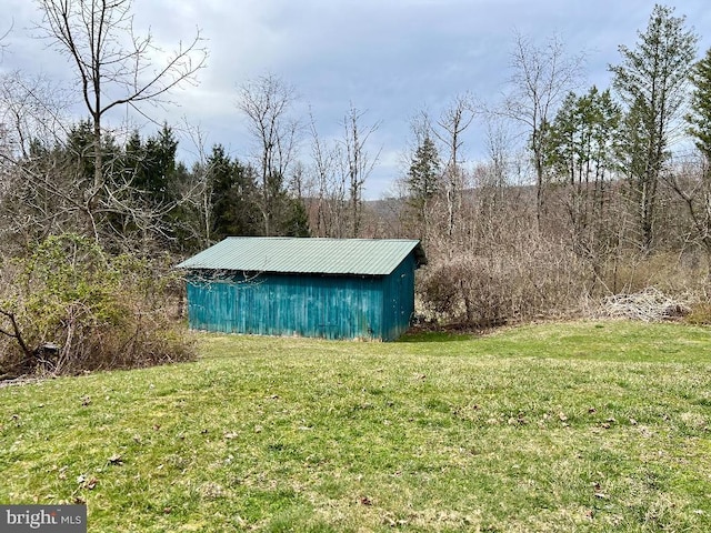 view of outbuilding with a lawn