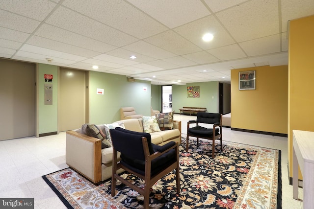 living room featuring a drop ceiling and elevator