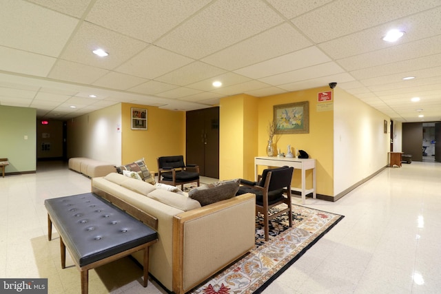 living room featuring a paneled ceiling