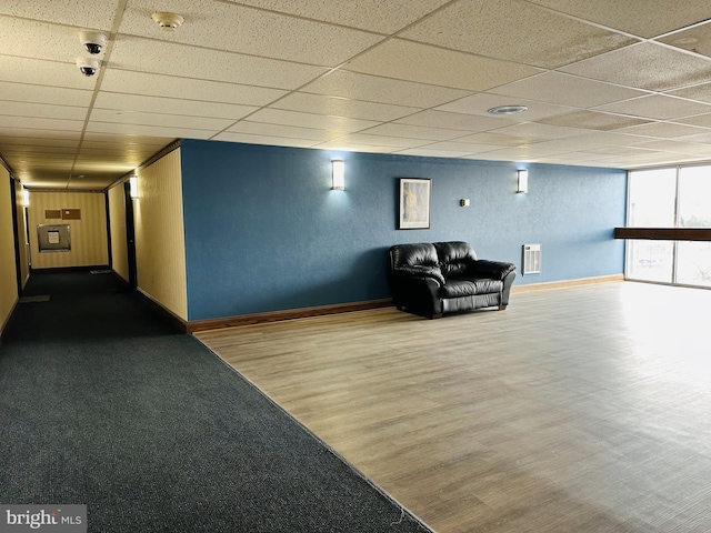 unfurnished room featuring hardwood / wood-style floors and a paneled ceiling