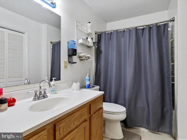 bathroom with walk in shower, vanity, and toilet