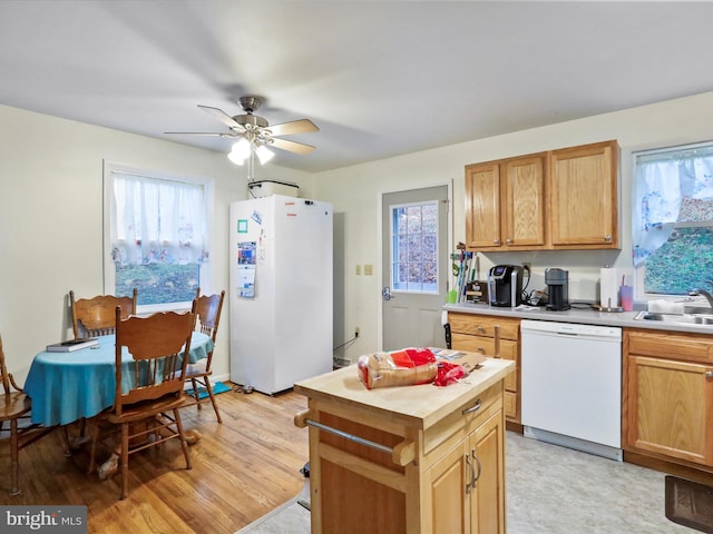 kitchen with white appliances, sink, ceiling fan, light hardwood / wood-style floors, and butcher block counters